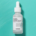 COSRX AHA BHA Vitamin C Booster Serum on turquoise background